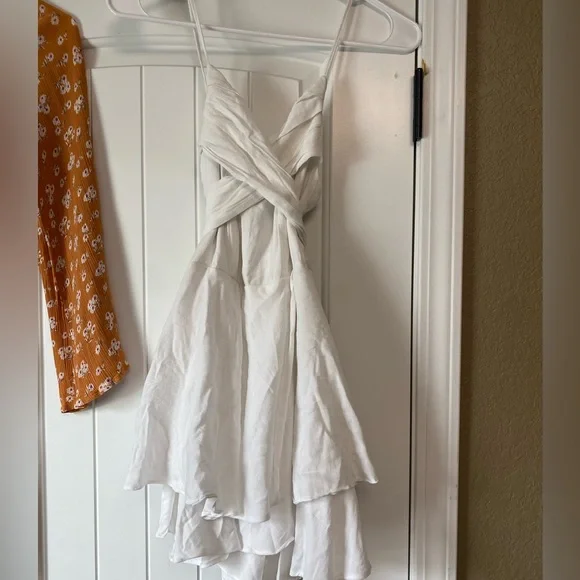 Purchased at Blu Spero, white romper with tie in the back bow. - Picture 2 of 3